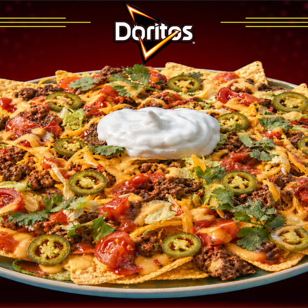 Doritos nachos with ground beef, cheese, tomatoes, jalapeños, and sour cream.